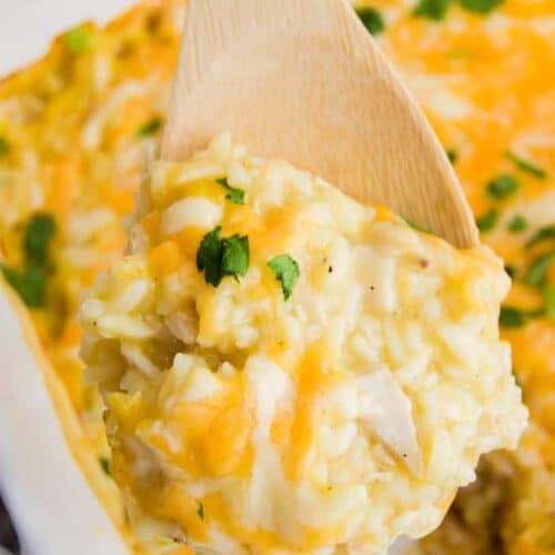 using a spoon to scoop out chicken and rice casserole