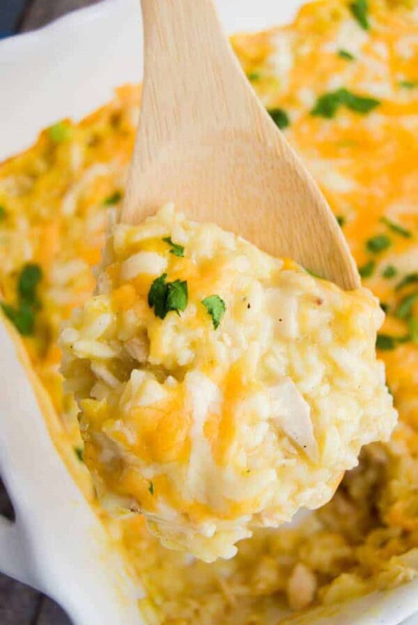 using a spoon to scoop out chicken and rice casserole