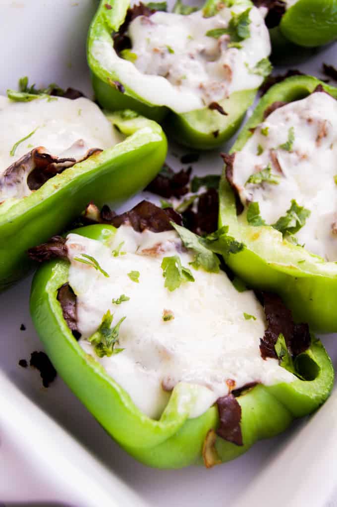 closeup of stuffed peppers in baking dish.