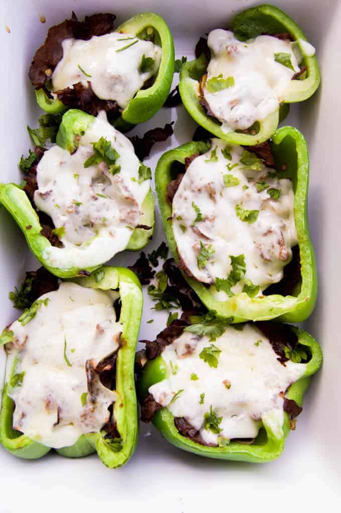 Philly Cheesesteak Stuffed Peppers in a white casserole dish fully cooked.