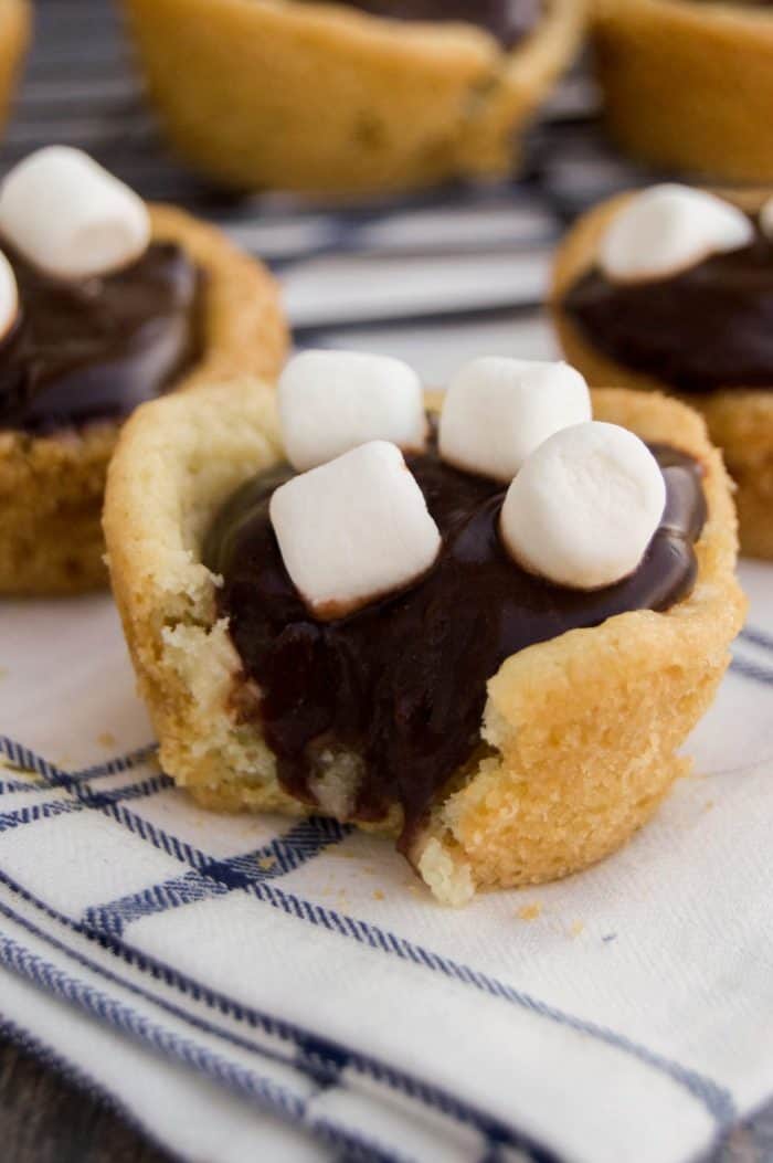 Closeup of Hot Chocolate cookie cups cut open to see inside filling on white towel