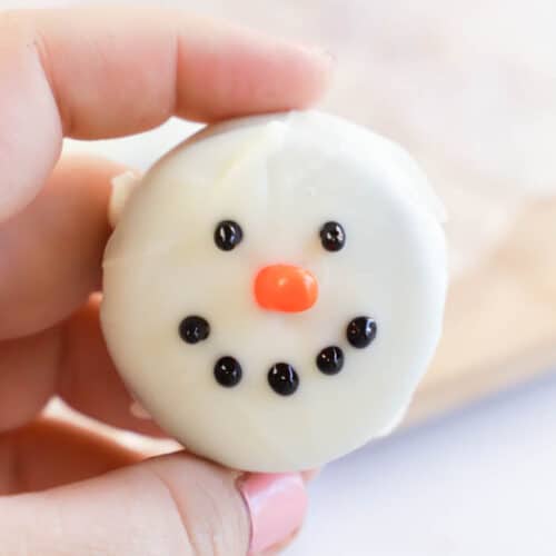 holding Snowmen Oreo Cookie in hand