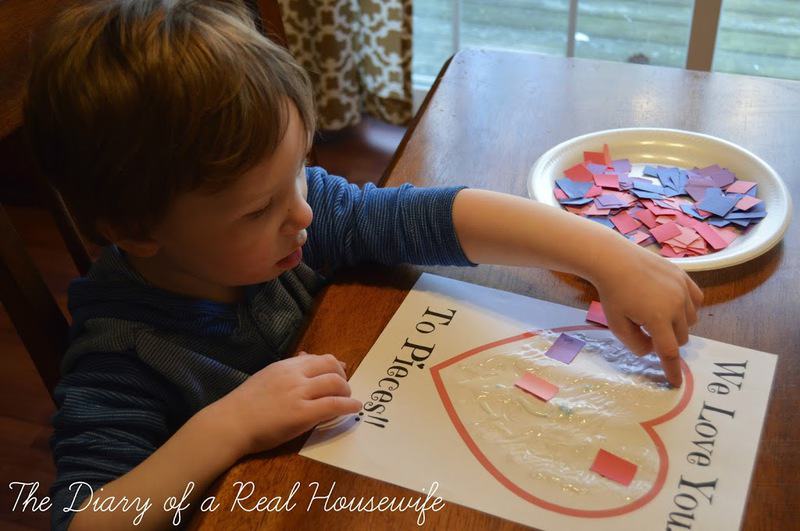 Little boy gluing scraps of paper to the printout