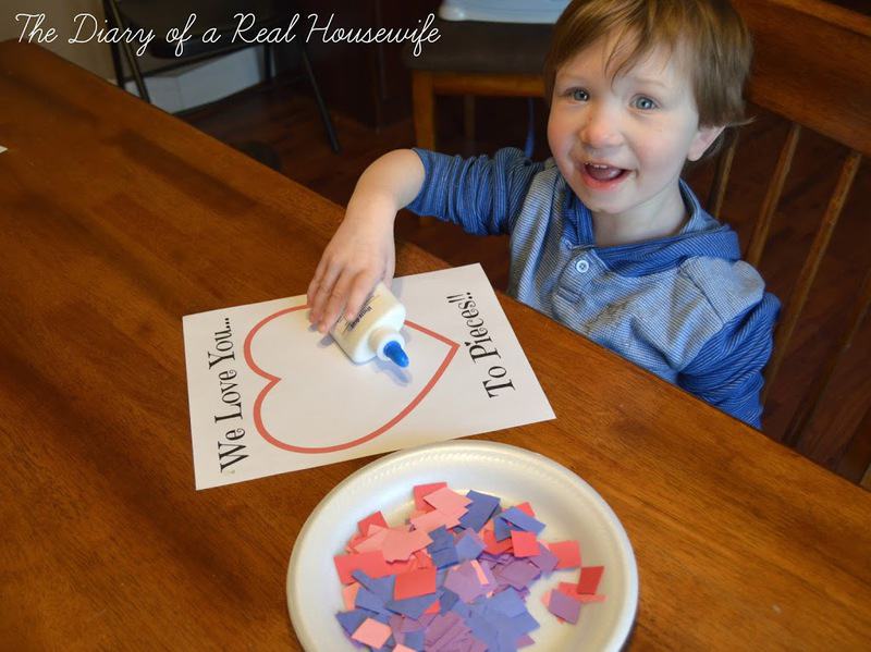 Smiling little boy about to glue the scraps of paper on the printout