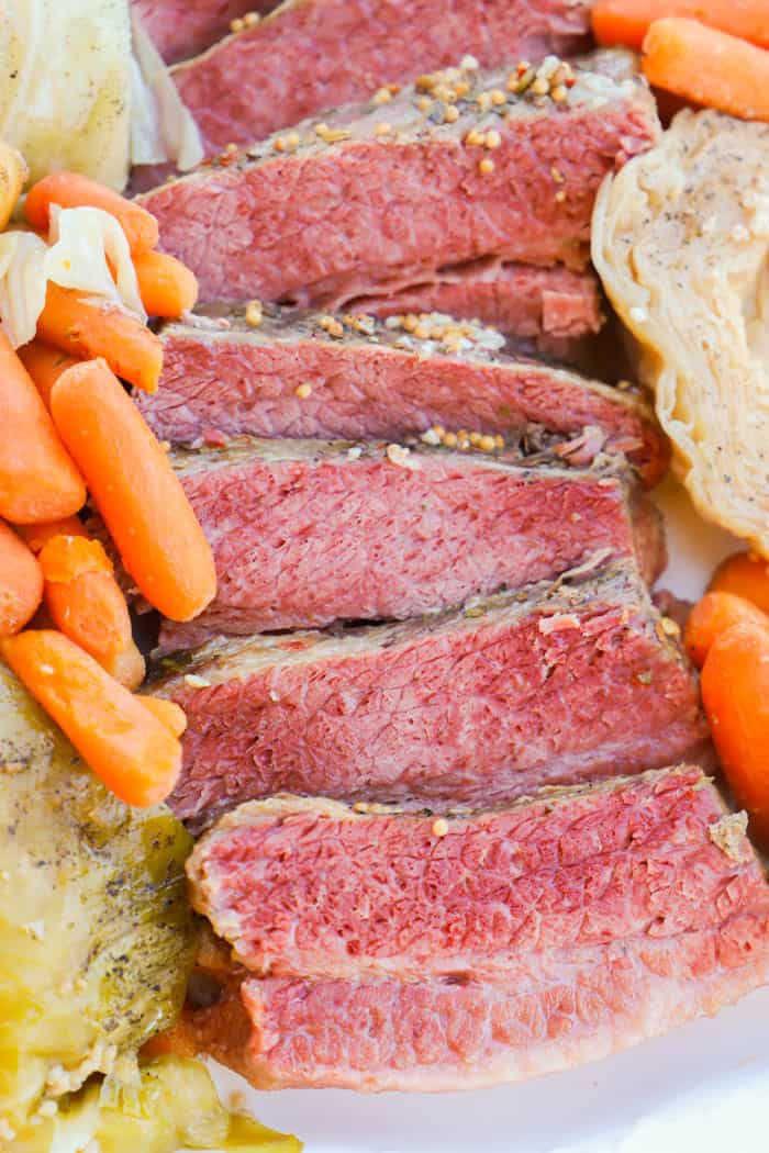 Close up shot of corned beef and cabbage and carrots and potatoes.