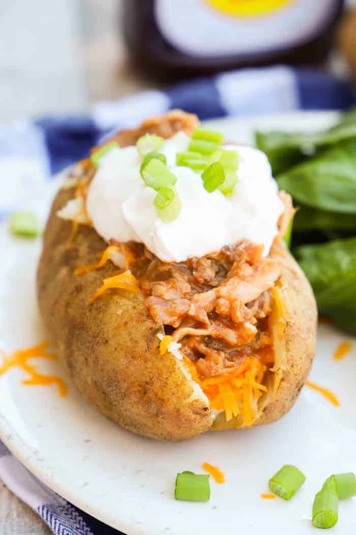 BBQ Pulled Pork Potato Skins topped with sour cream and green onions