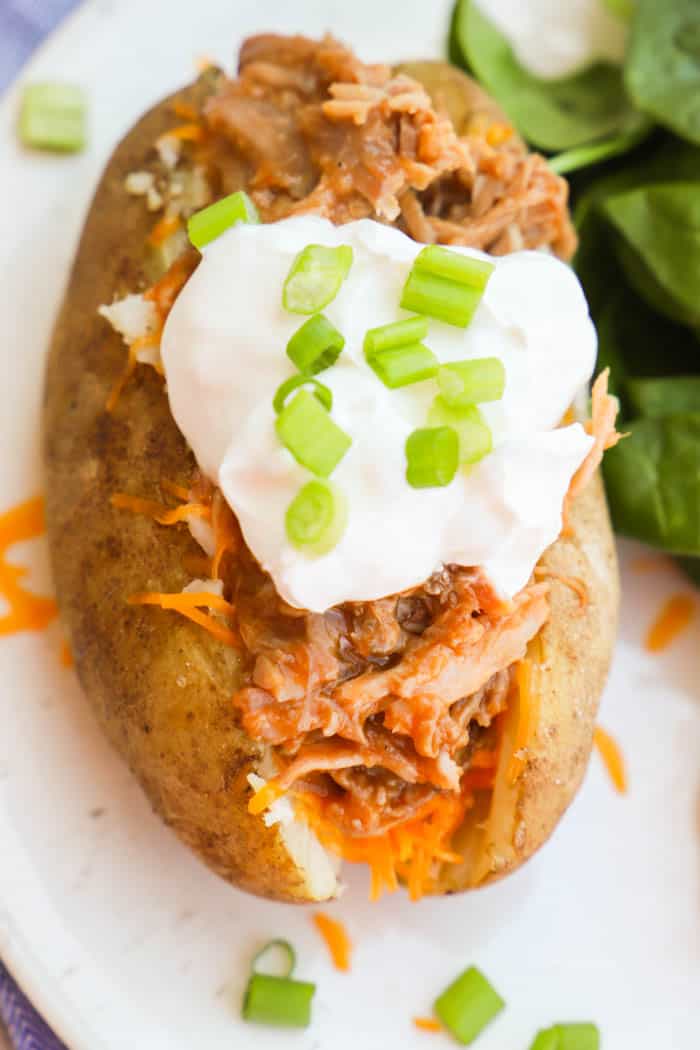 Top view of BBQ Pulled Pork Potato Skins with sour cream on top