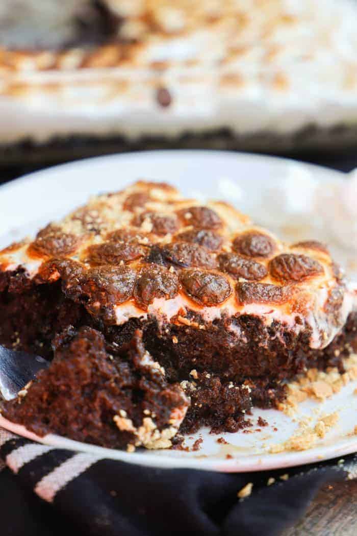 Close up picture of S'mores Poke Cake on a plate