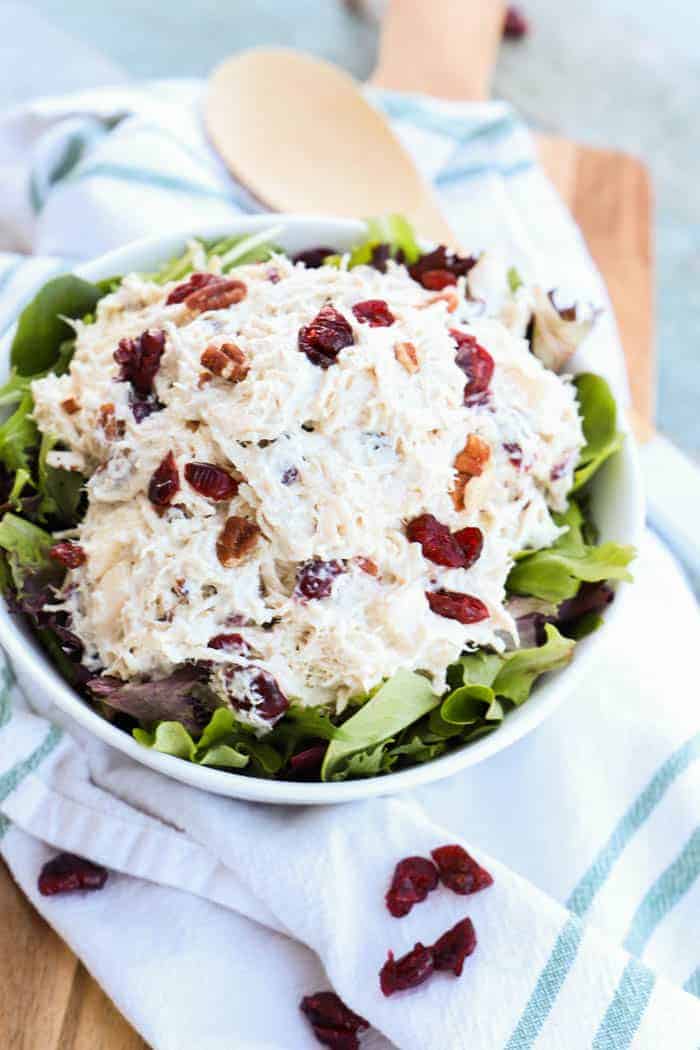 Apple Pecan Greek Yogurt Chicken Salad in a while bowl on a green towel