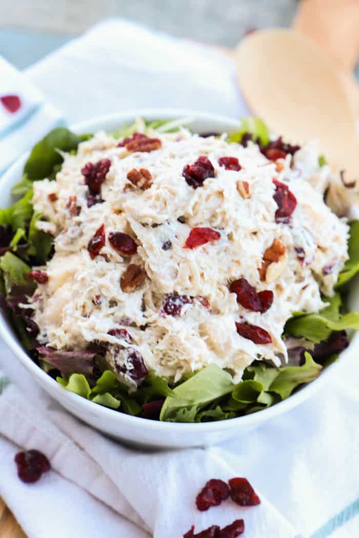 Apple Pecan Greek Yogurt Chicken Salad with a wooden spoon