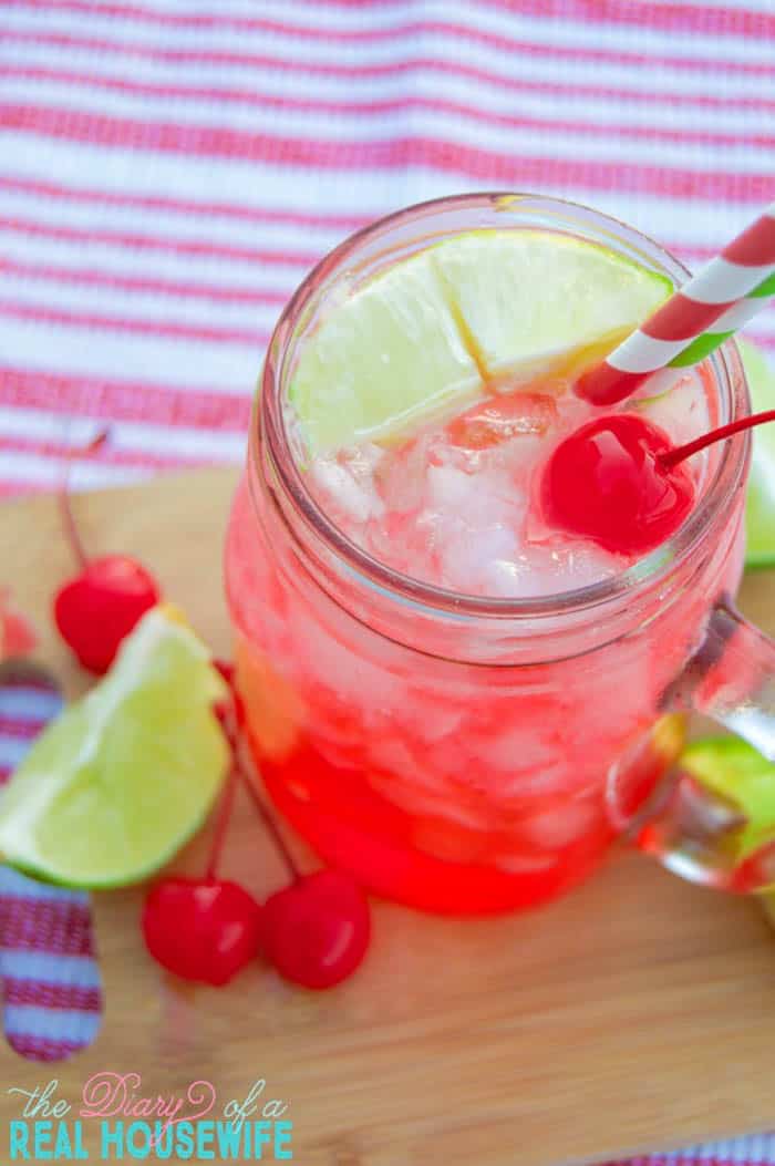 Cherry Limeade on wooden board with limes and cherries