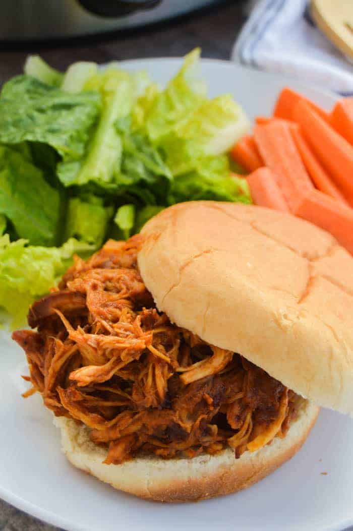 slow cooker root beer chicken in a sandwich