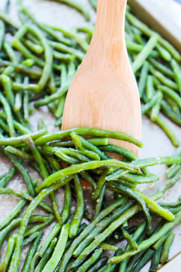 Baked Garlic Green Beans being served off the baking sheet