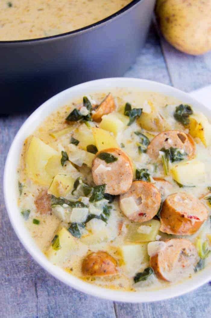 Creamy Smoked Sausage Spinach and Potato Soup in a white bowl