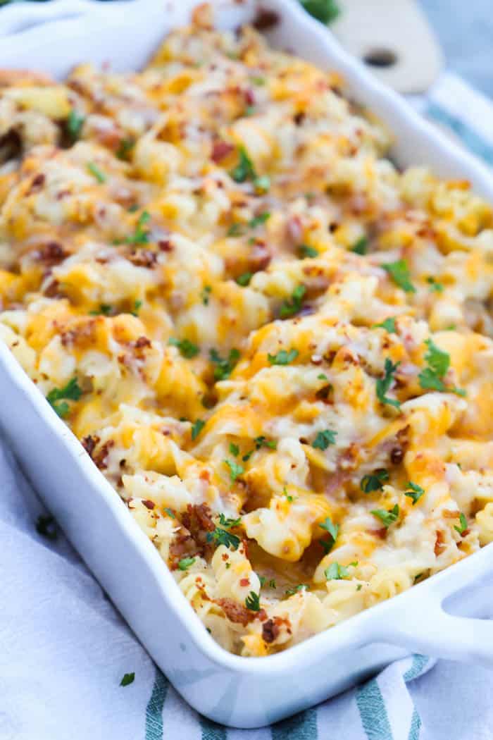 Chicken Bacon Ranch Casserole in white casserole dish on white towel with green stripes