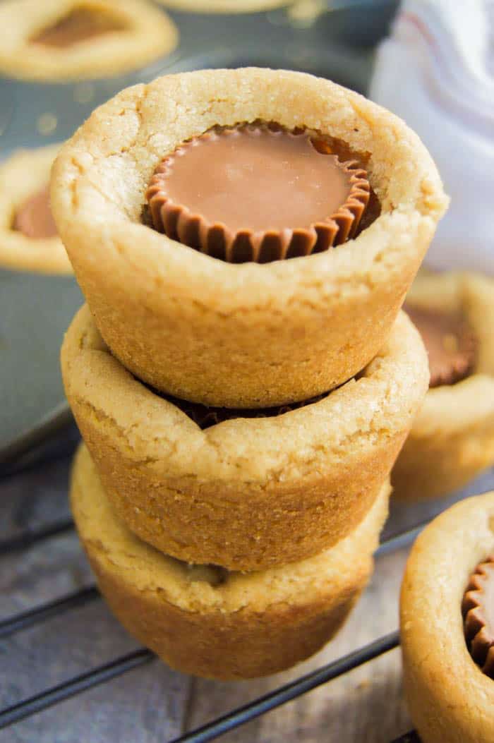 3 Peanut Butter Cup Cookies stacked on top of a wire rack