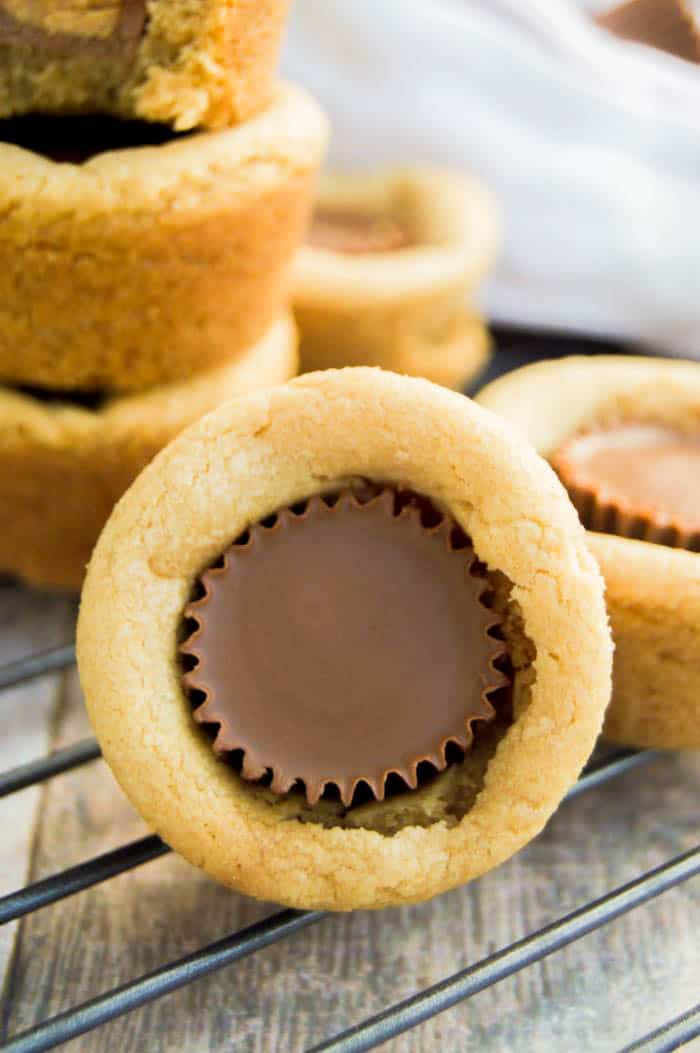 Tilted view of Peanut Butter Cup Cookies focusing on the peanut butter cup, on wire rack