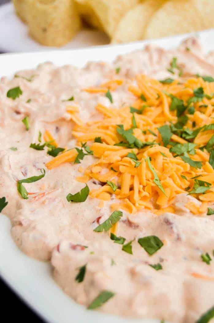 Fiesta Taco Dip on white plate with tortilla chips