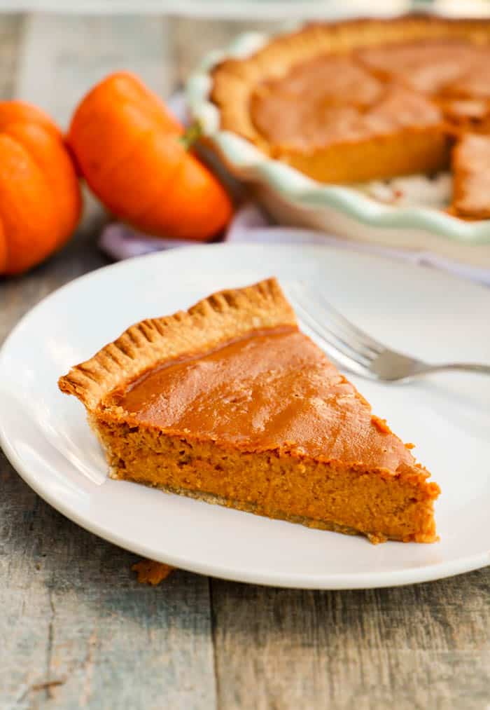 pumpkin pie on white plate.