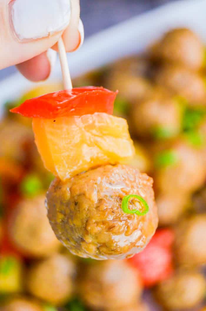 Slow Cooker Sweet and Sour Meatballs on toothpick with pineapple and red bell pepper