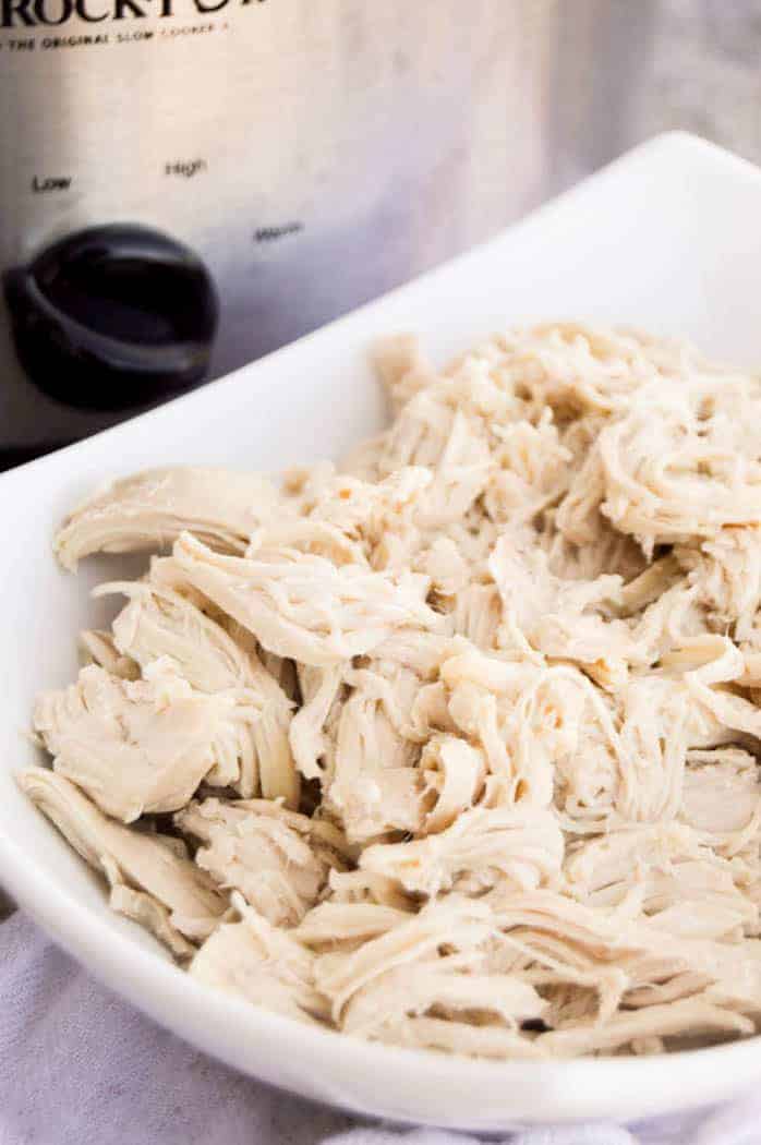 All Purpose Slow Cooker Chicken outside slow cooker in white bowl