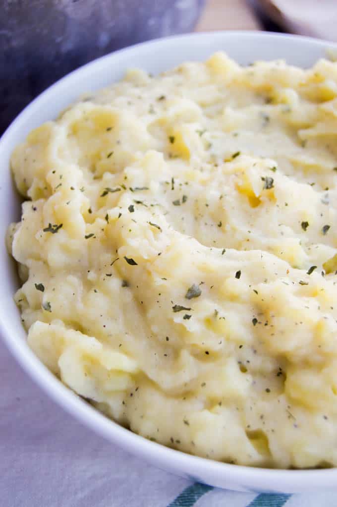 Skinny Mashed Potatoes in a white bowl on a towel