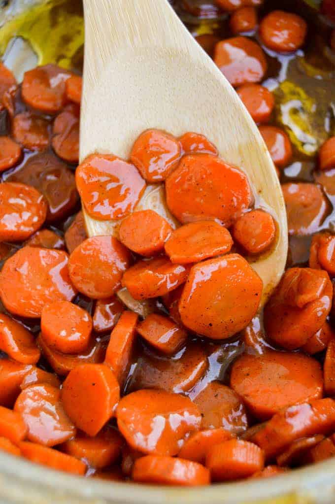 Brown Sugar Glazed Carrots on a wooden spoon