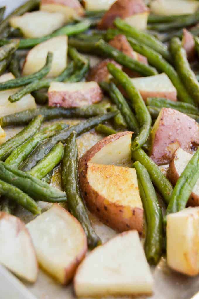 closeup of roasted green beans and potatoes.