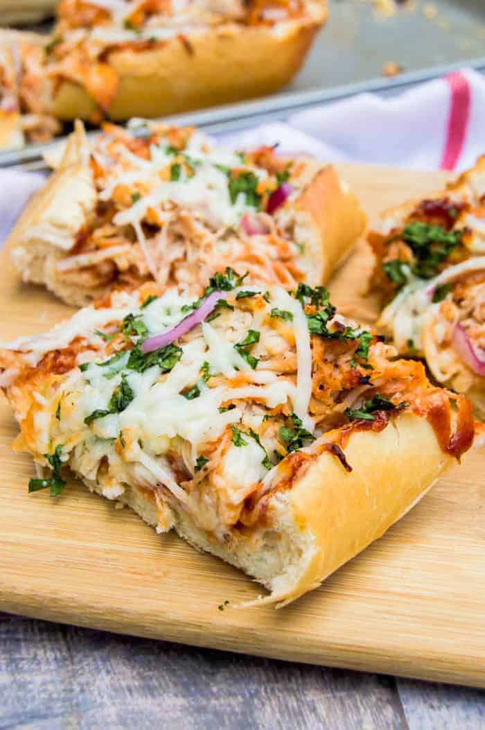 BBQ Chicken French Bread Pizza sliced on wooden serving board.