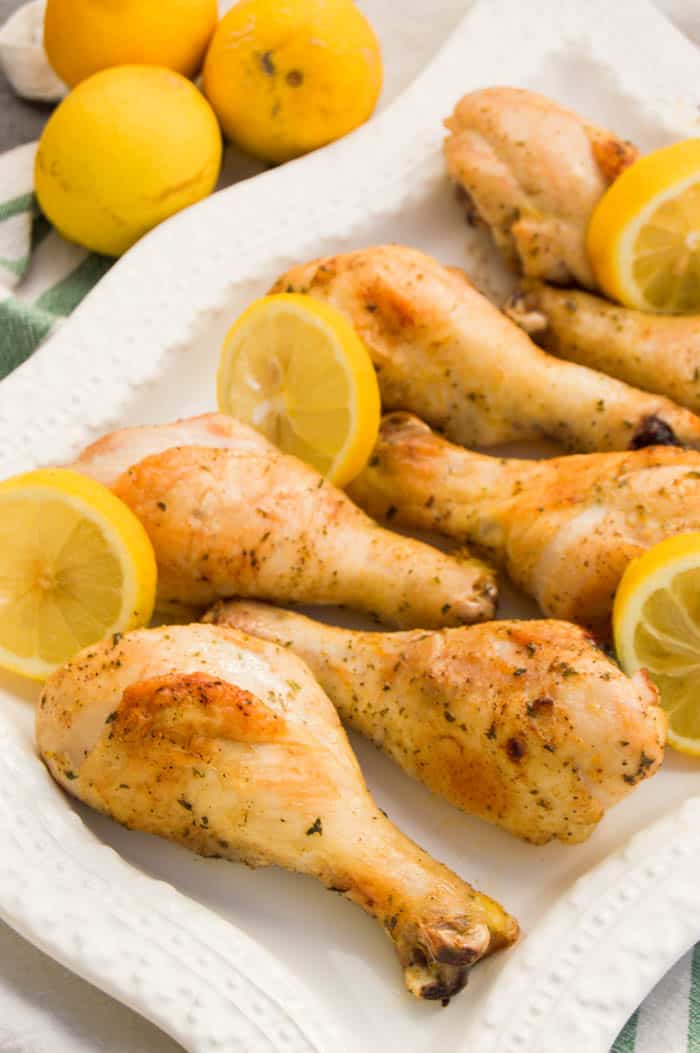 Lemon Pepper Chicken Drumsticks baked on white serving tray