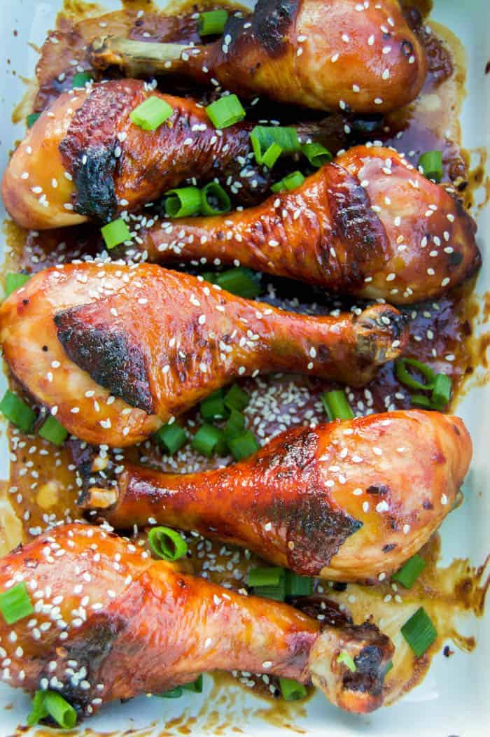 Asian Chicken Drumsticks closeup on white serving tray.