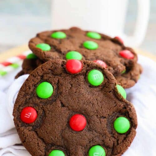 Chocolate M&M Christmas Cookie on a napkin with milk