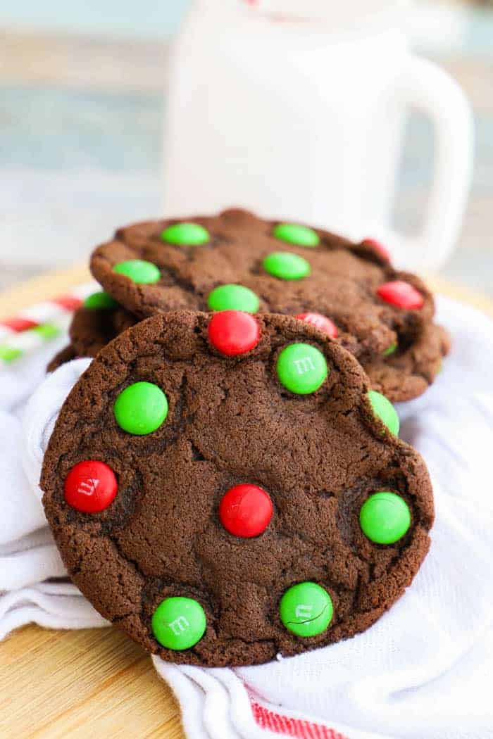 Chocolate M&M Christmas Cookie on a napkin with milk