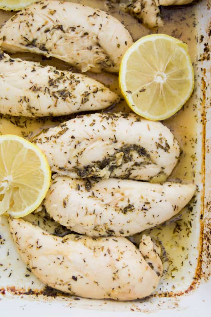 Lemon Garlic Chicken Tenders baked and garnished with fresh lemons