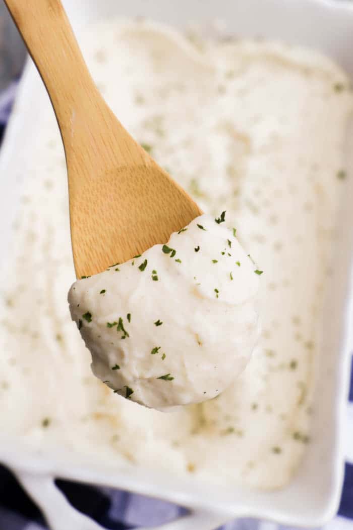 make ahead mashed potatoes scooped on wooden spoon