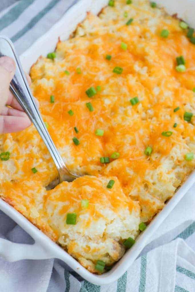 Hashbrown casserole in white dish on blue stripe towel