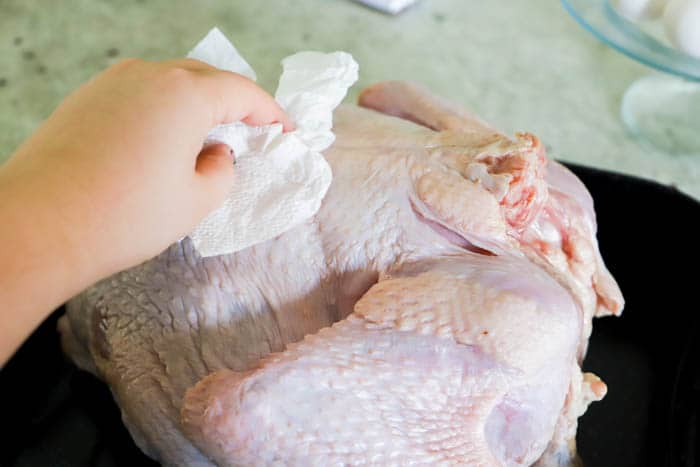 patting turkey dry with paper towel.
