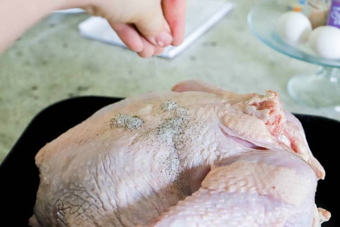 seasoning the turkey.