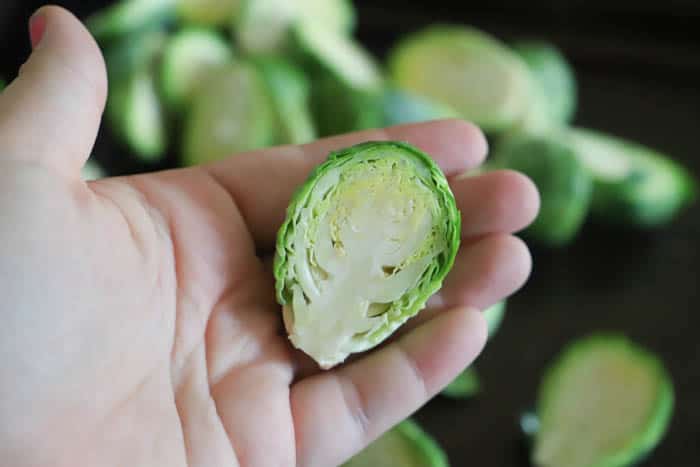 Roasted Brussel Sprouts cut in half in hand
