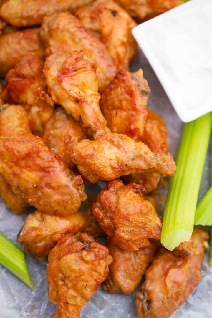 Buffalo Chicken Wings on serving tray with dip and celery.