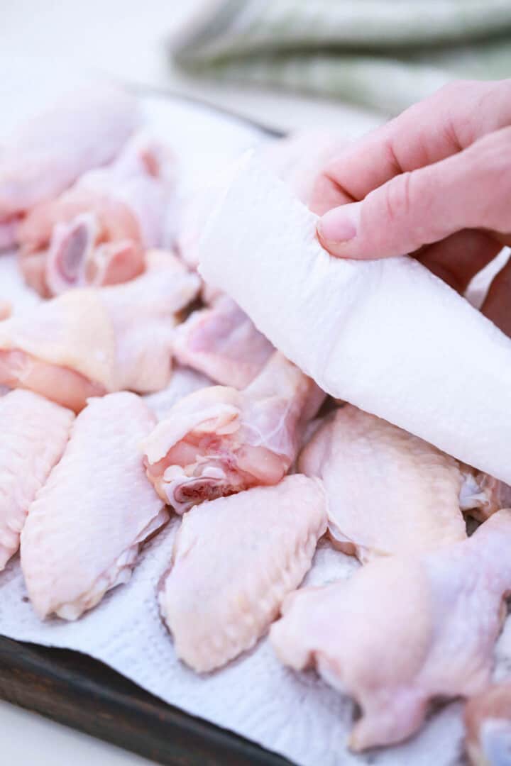 patting the wings dry with a paper towel