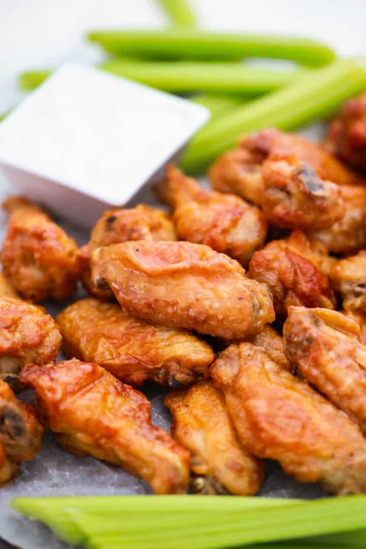 closeup of Buffalo chicken wings on serving plate.