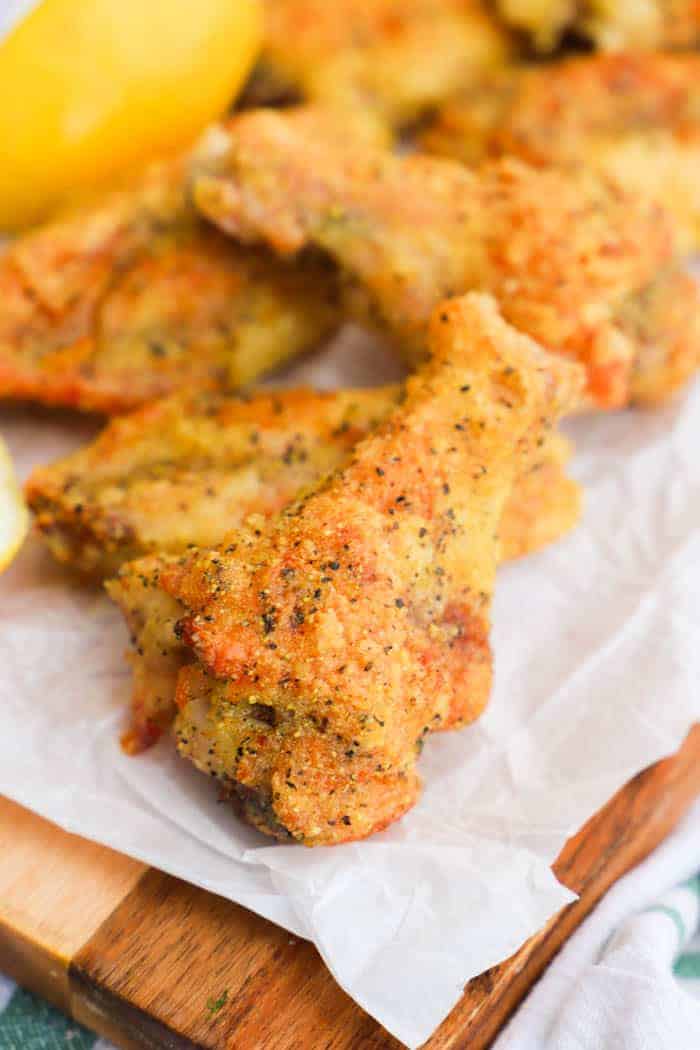 Crispy Baked Lemon Pepper Wings on parchment paper.