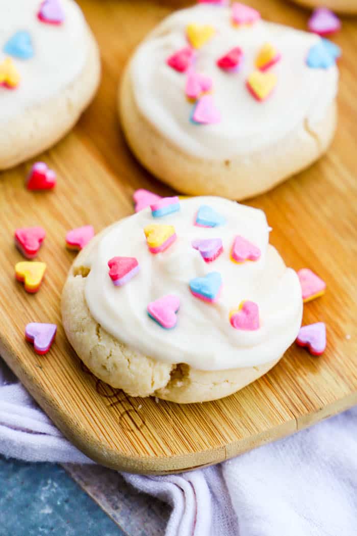 Valentine's Day Sugar Cookies on wooden serving board.