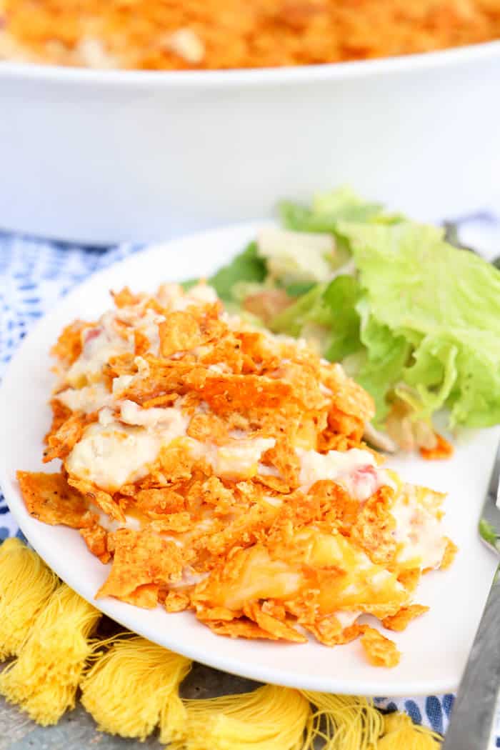 Dorito Chicken Casserole on white plate with salad