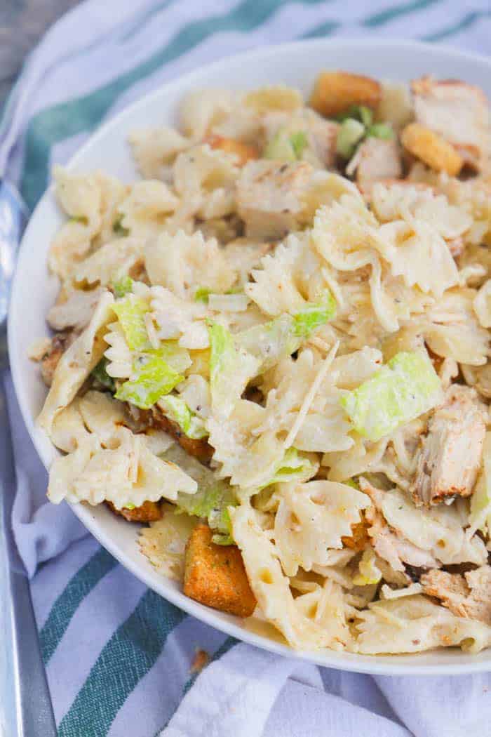 Chicken Caesar Pasta Salad in a white serving bowl