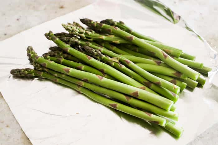 Grilled Asparagus laying on foil