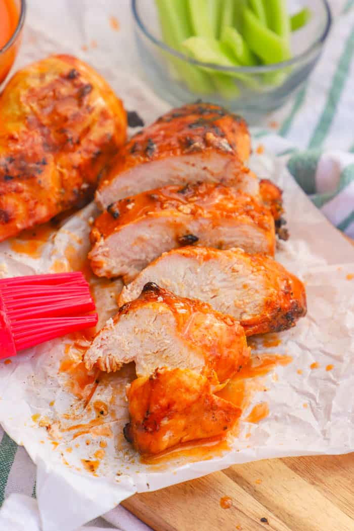 Grilled Buffalo Chicken sliced on a cutting board