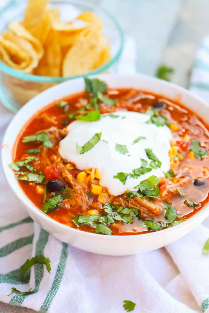 Close up picture of Pulled Pork Taco Soup in a white bowl