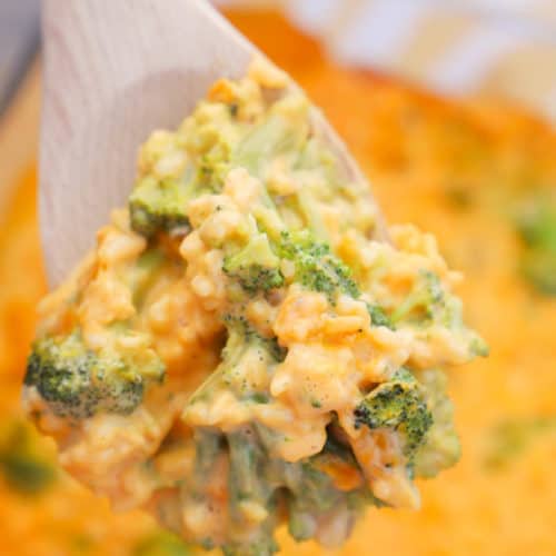 Cheesy Broccoli Casserole in a wooden spoon